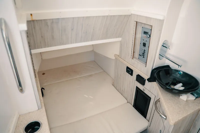 Slide: The Image of Interior cabin of 2019 HCB 42 Siesta boat with bed and control panel. - 6