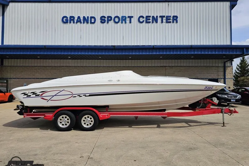 The Image of 1999 Baja 272 speedboat on red trailer at Grand Sport Center. - 1