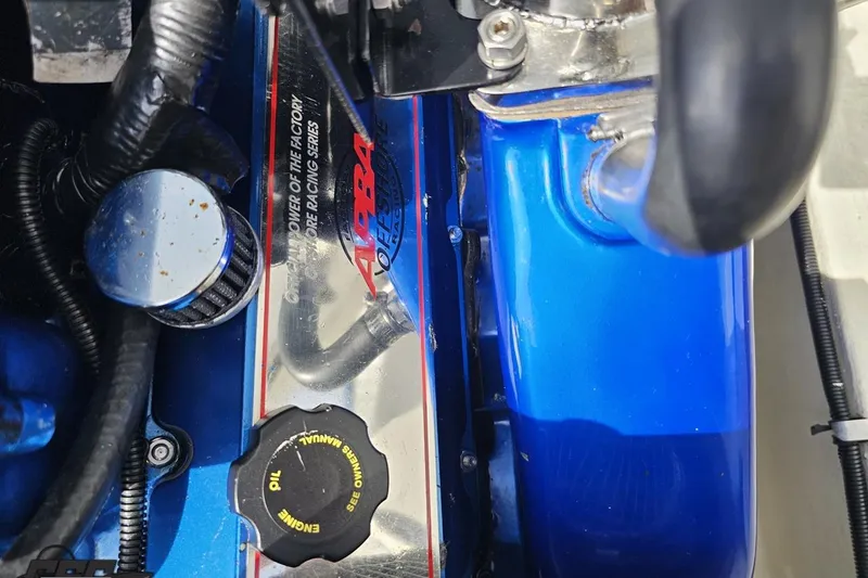 Slide: The Image of Close-up of a 1999 Baja 272 engine with blue components and oil cap. - 100