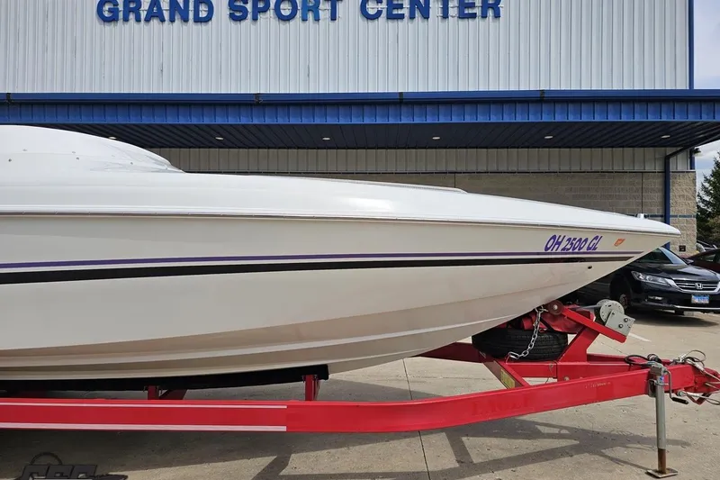 Slide: The Image of 1999 Baja 272 boat on red trailer at Grand Sport Center. - 13