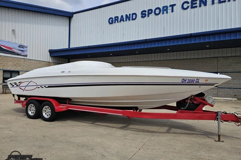 Slide: The Image of 1999 Baja 272 boat on red trailer at Grand Sport Center. - 14