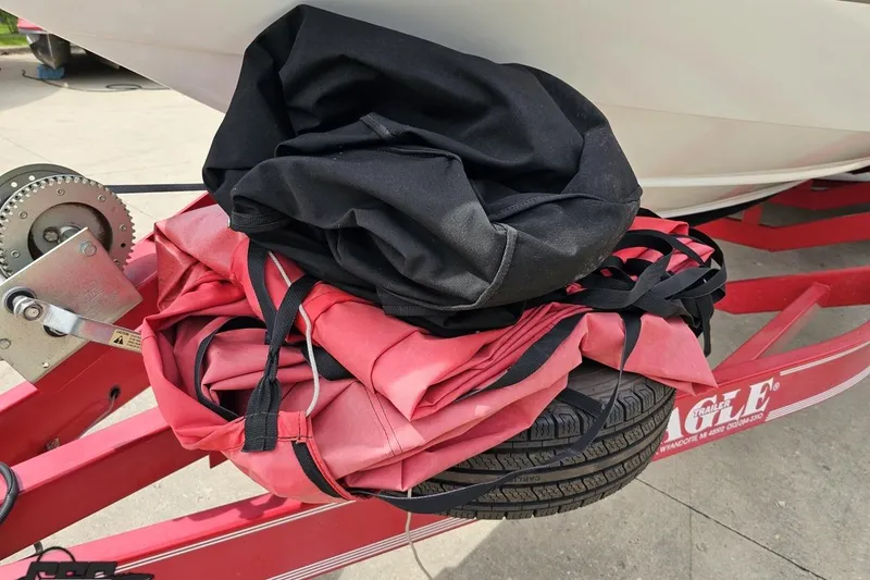 Slide: The Image of Red and black boat cover on trailer with Baja 272, 1999 model. - 18