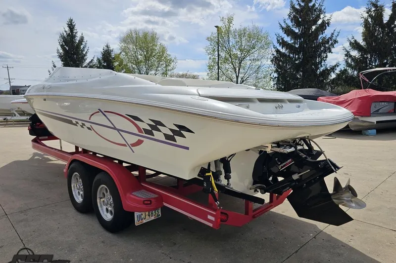 Slide: The Image of 1999 Baja 272 speedboat on a red trailer, featuring sleek design and vibrant graphics. - 29