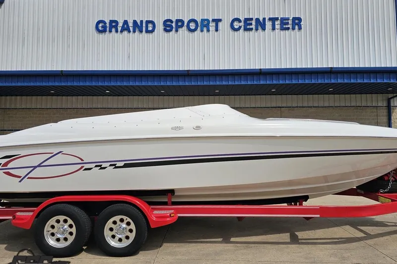 Slide: The Image of 1999 Baja 272 boat on red trailer at Grand Sport Center. - 3