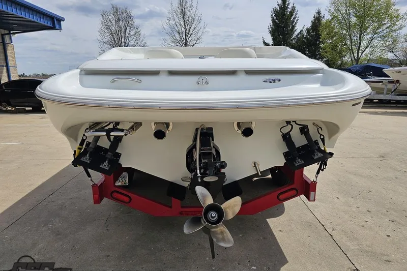 Slide: The Image of 1999 Baja 272 boat rear view with dual propellers on a trailer. - 31