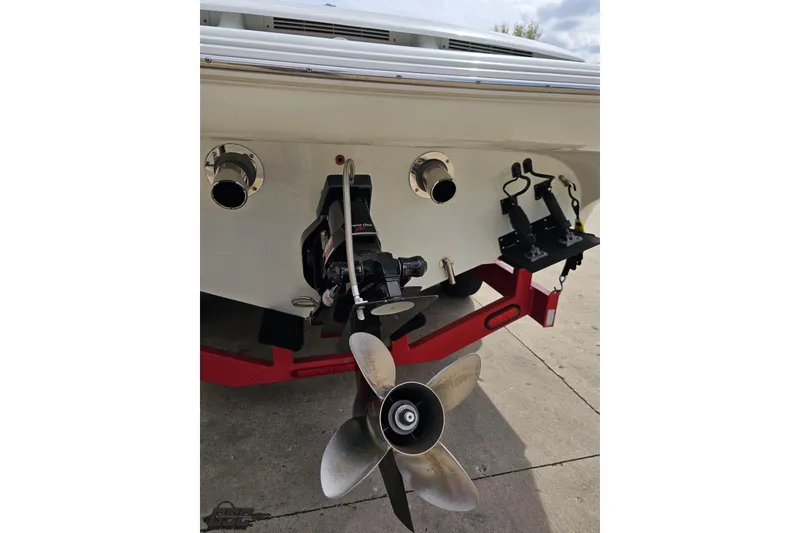 Slide: The Image of 1999 Baja 272 boat stern with propeller and exhaust, on a red trailer. - 34