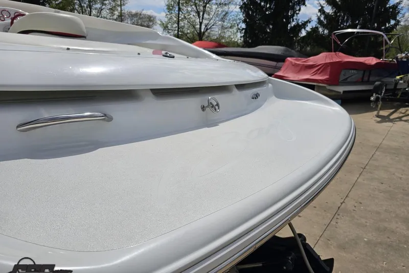 Slide: The Image of 1999 Baja 272 boat rear view with sleek white design and chrome details. - 38