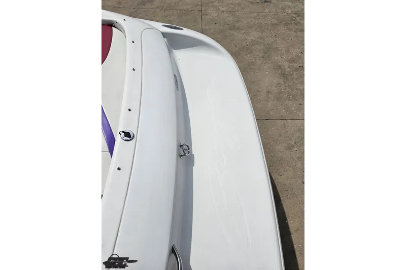 Slide: The Image of 1999 Baja 272 boat deck, featuring sleek white design and purple accents. - 39