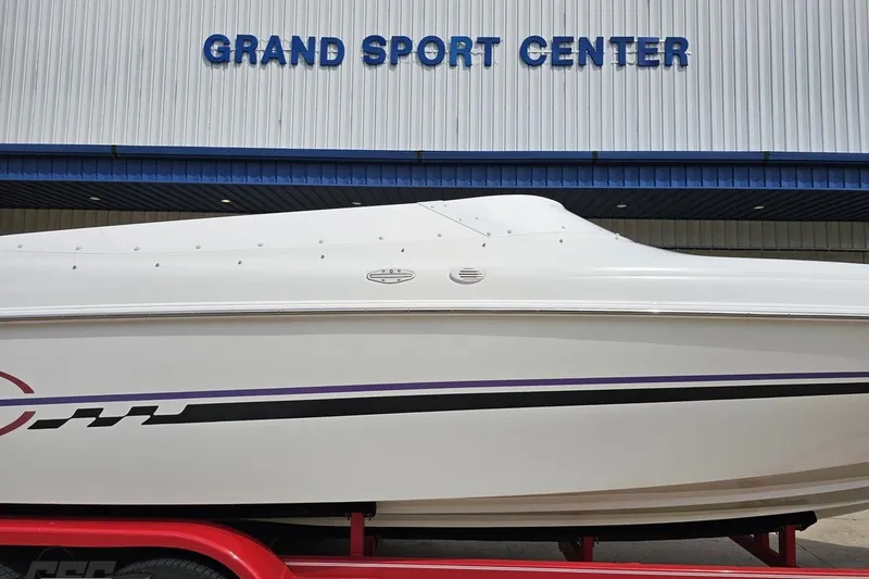Slide: The Image of 1999 Baja 272 boat at Grand Sport Center, featuring sleek white design with purple and black accents. - 4