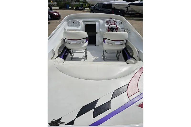 Slide: The Image of 1999 Baja 272 boat interior with white seating and colorful dashboard accents. - 41