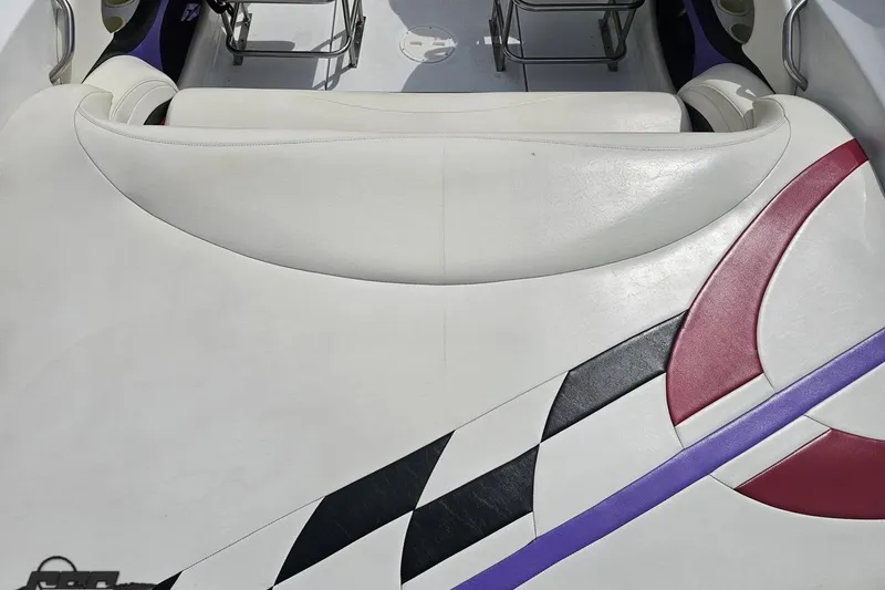 Slide: The Image of 1999 Baja 272 boat interior with white, red, and black upholstery design. - 42