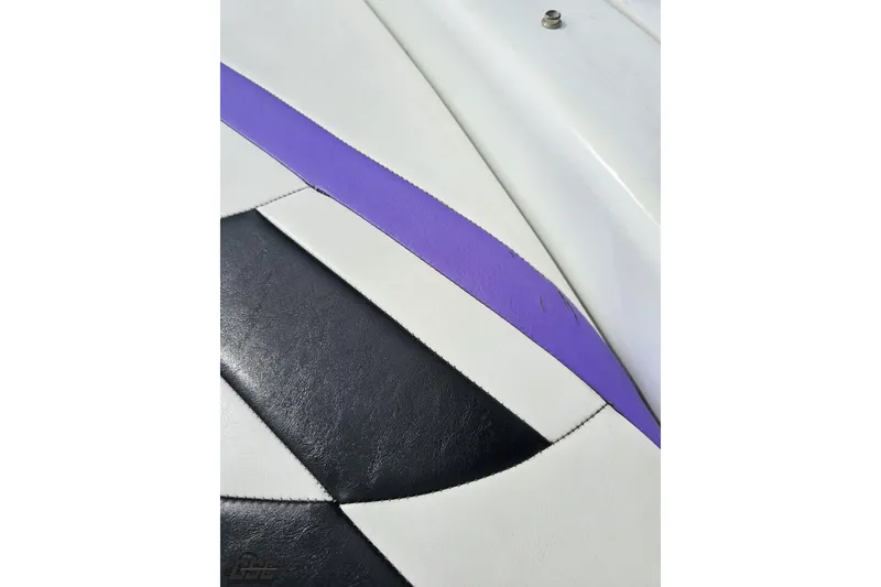 Slide: The Image of Close-up of 1999 Baja 272 boat upholstery with black, white, and purple design. - 44