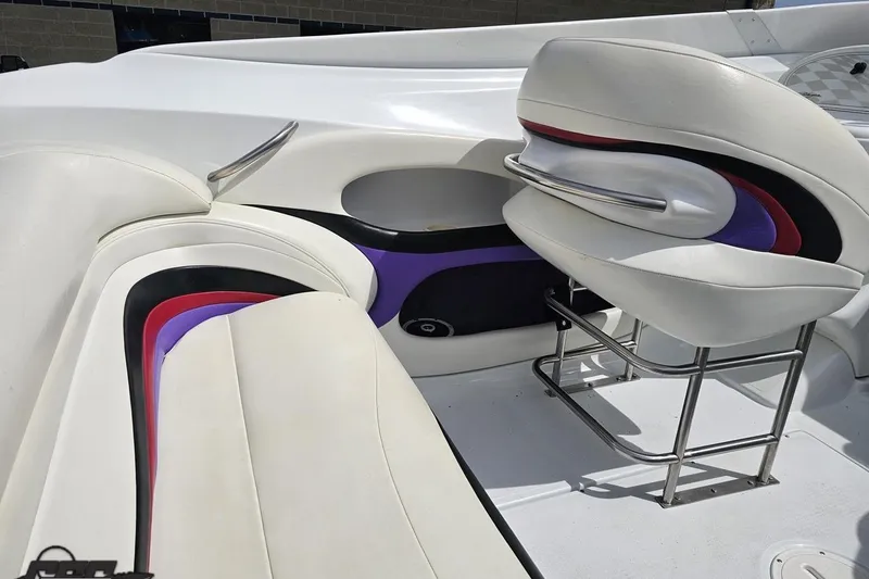 Slide: The Image of 1999 Baja 272 boat interior with white, purple, and red seating design. - 51