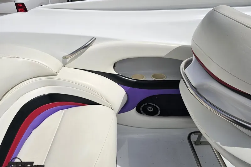 Slide: The Image of Interior of a 1999 Baja 272 boat with white and colorful seating. - 52