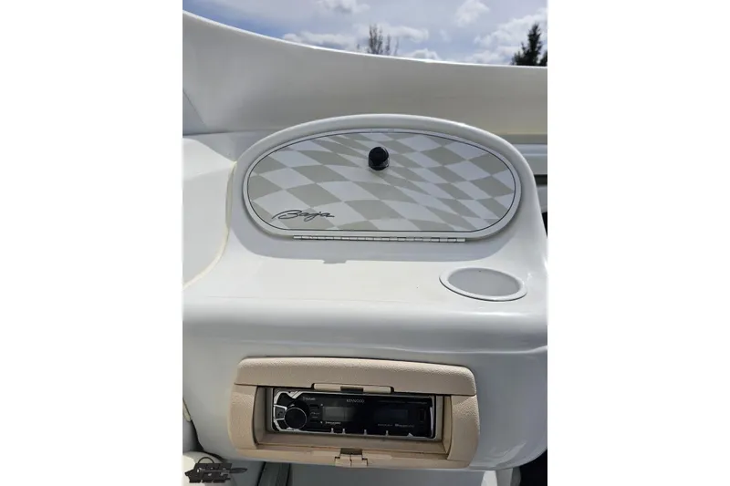 Slide: The Image of 1999 Baja 272 boat dashboard with stereo system and cup holder. - 55