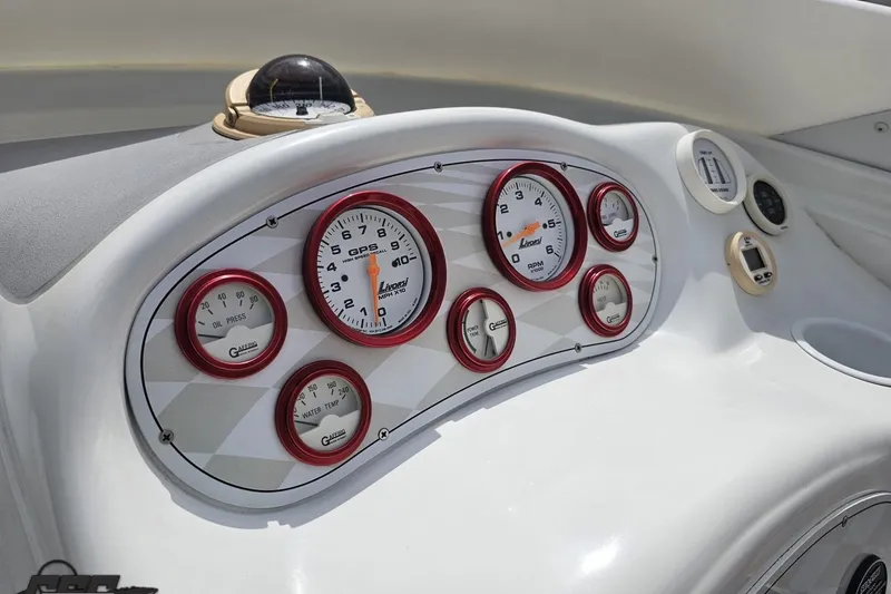 Slide: The Image of Dashboard of a 1999 Baja 272 boat with gauges and compass. - 61