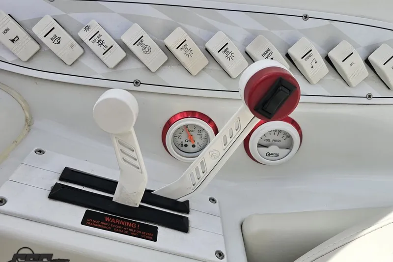 Slide: The Image of Control panel of a 1999 Baja 272 boat with switches and gauges. - 63