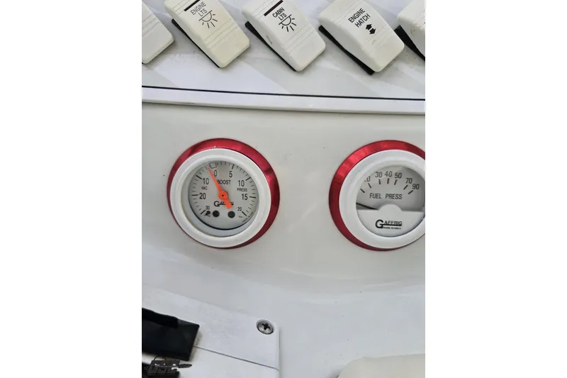 Slide: The Image of 1999 Baja 272 dashboard with boost and fuel pressure gauges, white switches above. - 64