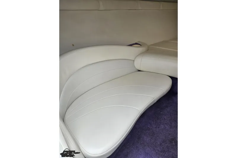 Slide: The Image of Interior of a 1999 Baja 272 boat featuring white leather seating and purple carpet. - 70