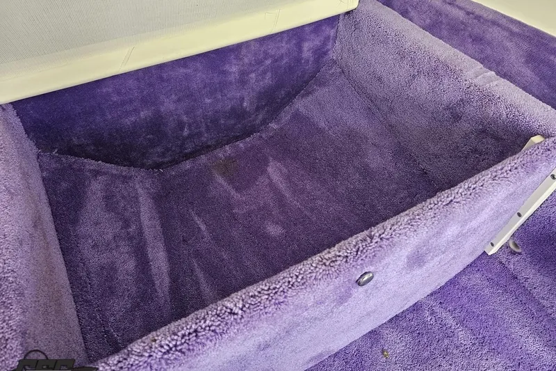 Slide: The Image of Purple carpeted interior of a 1999 Baja 272 boat. - 75