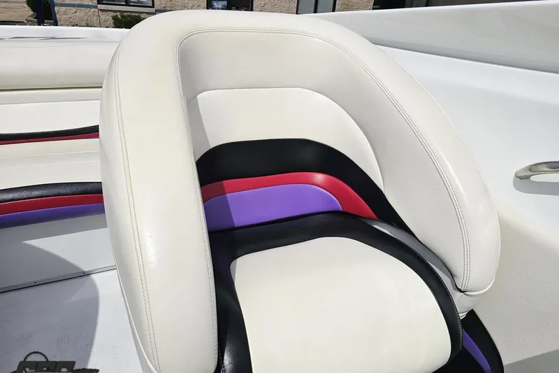 Slide: The Image of 1999 Baja 272 boat seat with white, black, red, and purple upholstery design. - 81