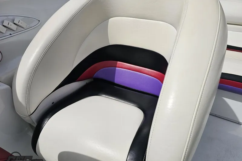 Slide: The Image of 1999 Baja 272 boat seat with white, black, red, and purple upholstery. - 82