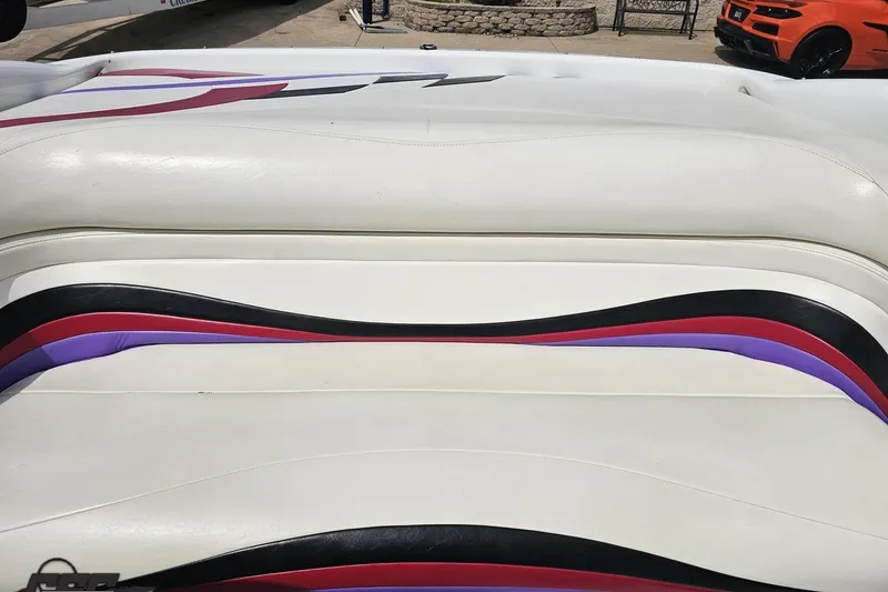 Slide: The Image of White leather boat seat with colorful stripes, Baja 272, 1999 model. - 83