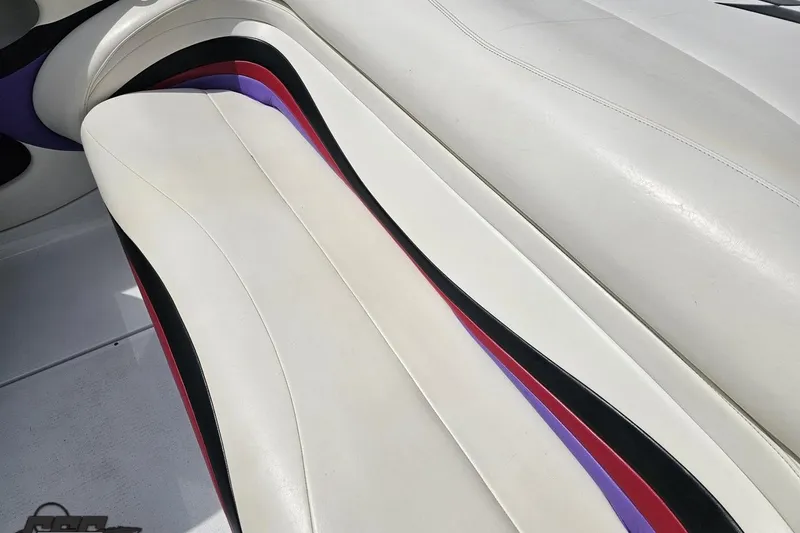 Slide: The Image of White leather boat seat with colorful accents in a 1999 Baja 272. - 85