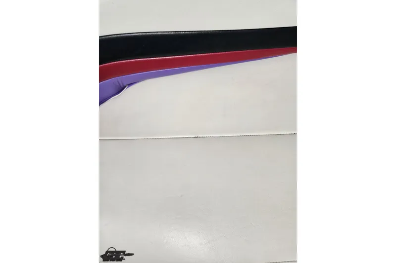 Slide: The Image of Interior detail of a 1999 Baja 272 boat, featuring colorful upholstery design. - 86