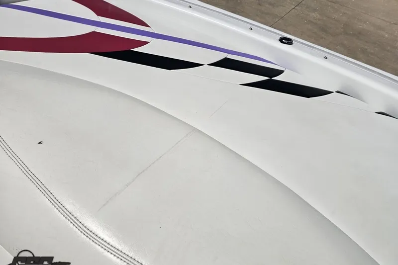 Slide: The Image of 1999 Baja 272 boat with sleek white and red design accents on the deck. - 89