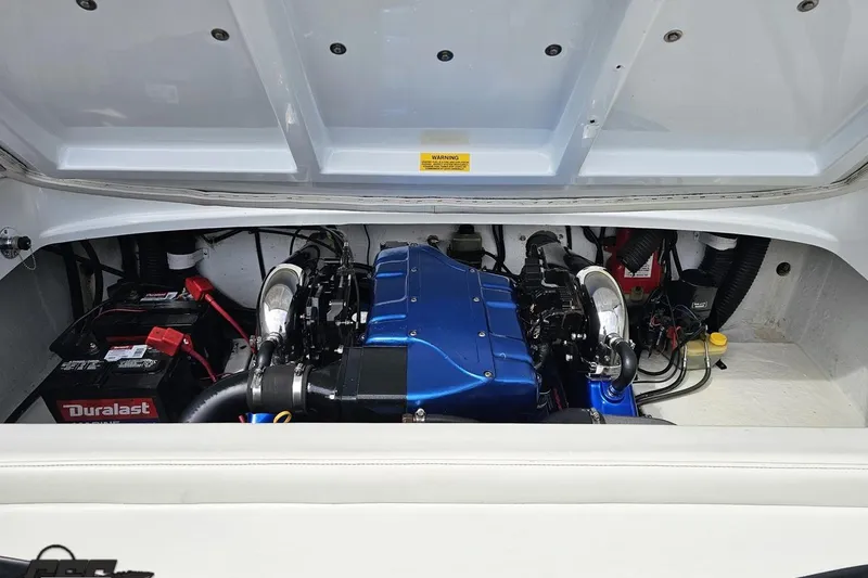 Slide: The Image of Engine compartment of a 1999 Baja 272 boat with visible Duralast battery. - 91