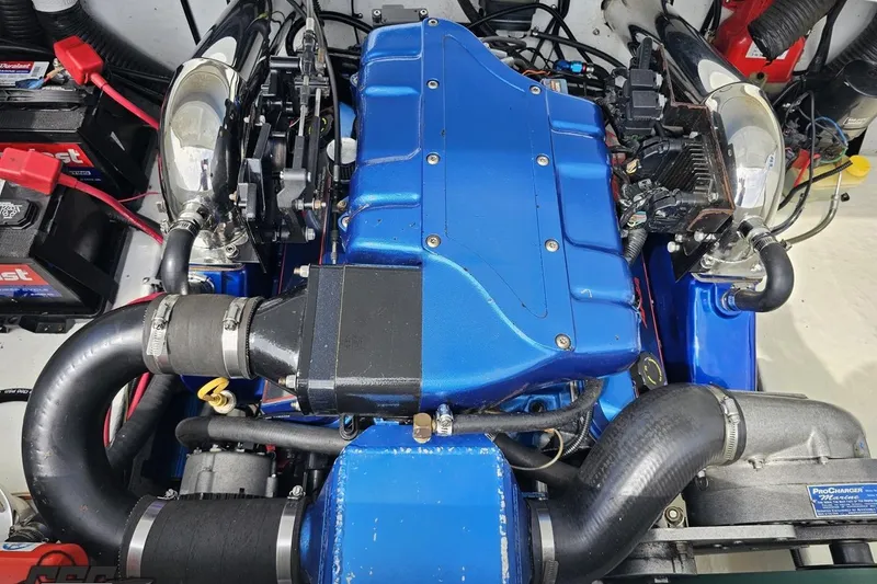Slide: The Image of Engine of a 1999 Baja 272 boat with blue components and visible wiring. - 96