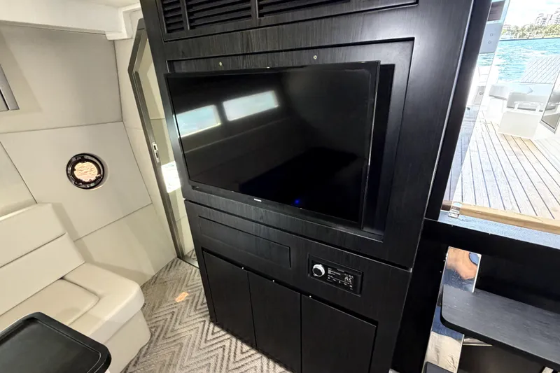 Slide: The Image of Interior of 2024 Schaefer 400 yacht featuring a sleek black entertainment system. - 10