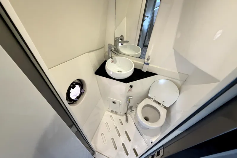 Slide: The Image of Compact bathroom in 2024 Schaefer 400 yacht, featuring modern sink and toilet design. - 15