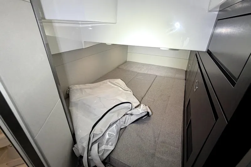 Slide: The Image of 2024 Schaefer 400 cabin interior with bed and storage compartments. - 16