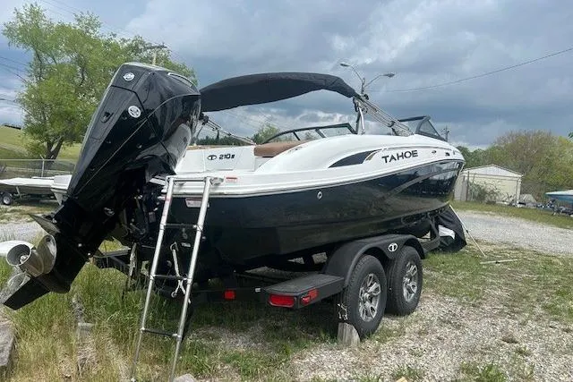 Slide: The Image of 2026 Tahoe 210 S boat on trailer, black and white design, parked outdoors. - 11