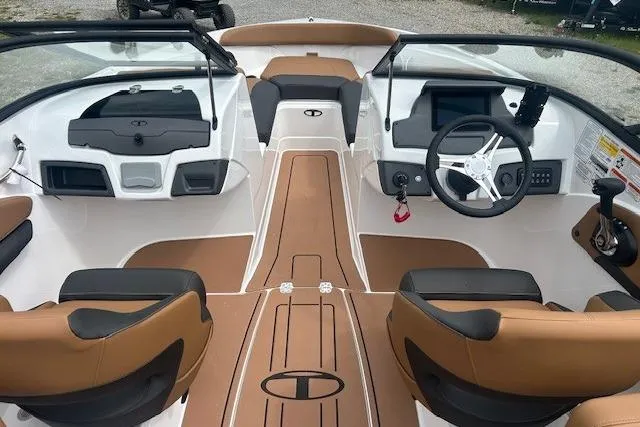 Slide: The Image of Interior view of 2026 Tahoe 210 S boat with brown and white seating. - 2