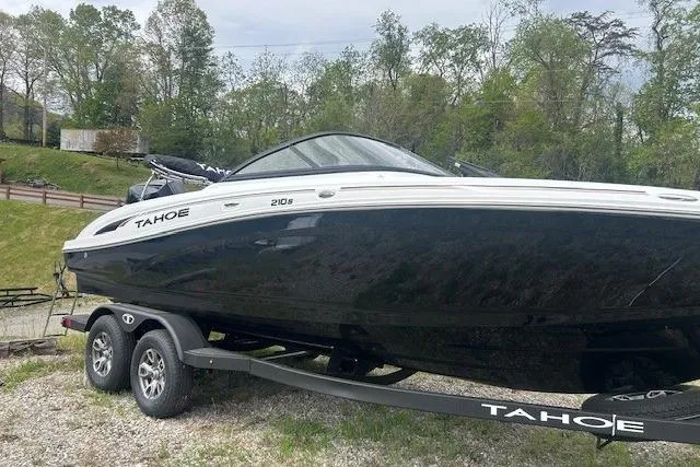 Slide: The Image of 2026 Tahoe 210 S boat on trailer, black and white design, parked outdoors. - 3