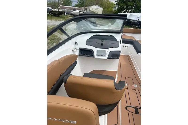 Slide: The Image of 2026 Tahoe 210 S boat interior with tan and black seating, sleek dashboard design. - 6
