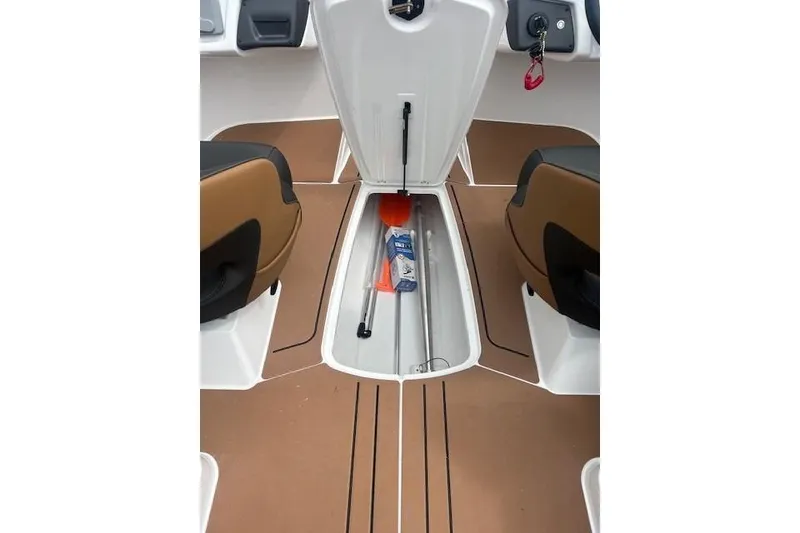 Slide: The Image of 2026 Tahoe 210 S boat storage compartment with safety equipment and accessories. - 7