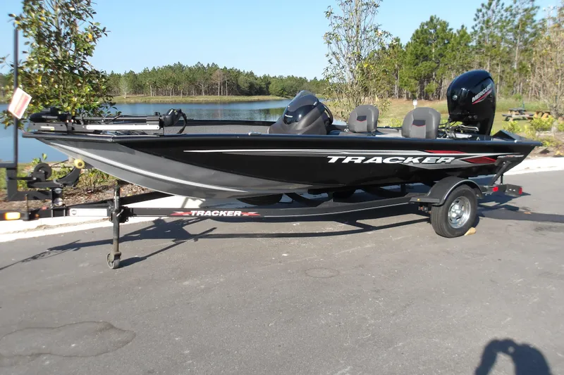 The Image of 2023 Tracker Pro Team 175 TXW boat on trailer by a lake. - 0
