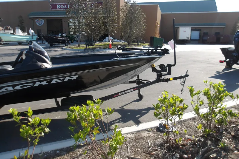 Slide: The Image of 2023 Tracker Pro Team 175 TXW boat on trailer in parking lot. - 2
