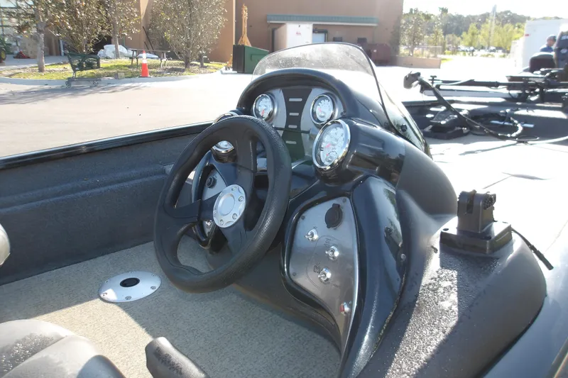Slide: The Image of 2023 Tracker Pro Team 175 TXW boat dashboard with steering wheel and gauges. - 8
