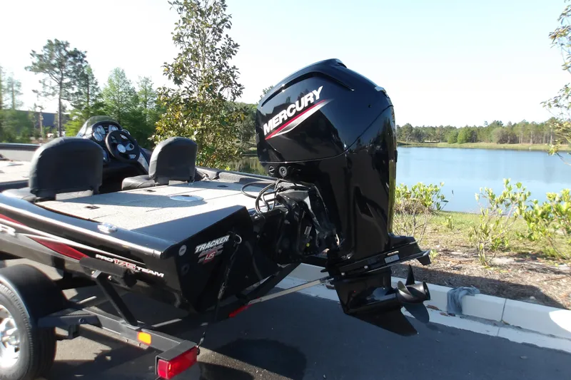 Slide: The Image of 2023 Tracker Pro Team 175 TXW boat with Mercury engine by a lake. - 9