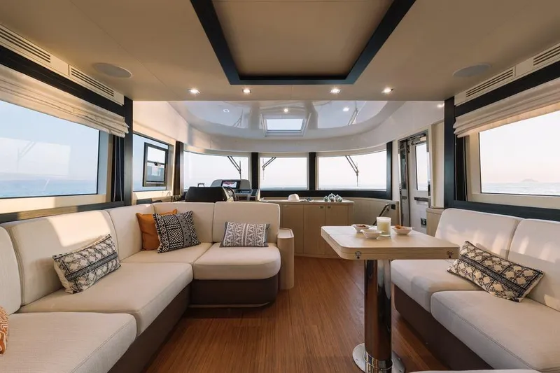 Slide: The Image of Luxurious interior of 2025 Sirena 58 yacht with elegant seating and panoramic windows. - 8