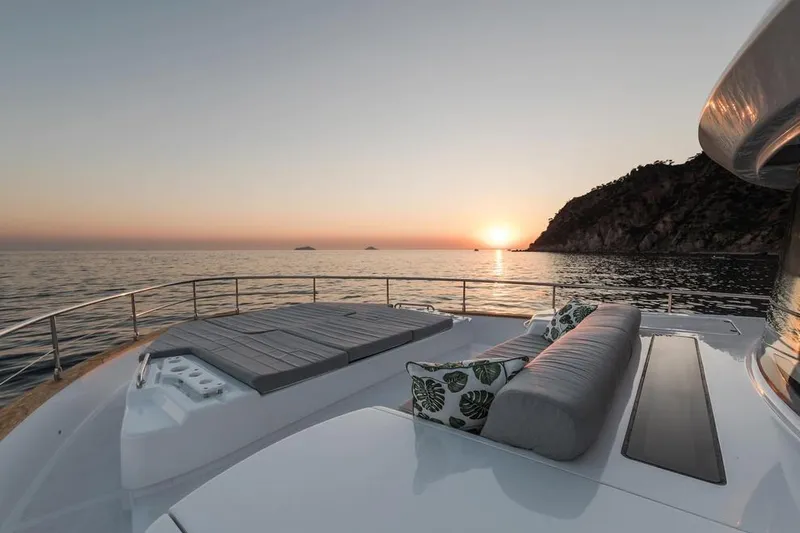 Slide: The Image of Luxurious Sirena 58 yacht deck at sunset, 2025 model, with scenic ocean view. - 9