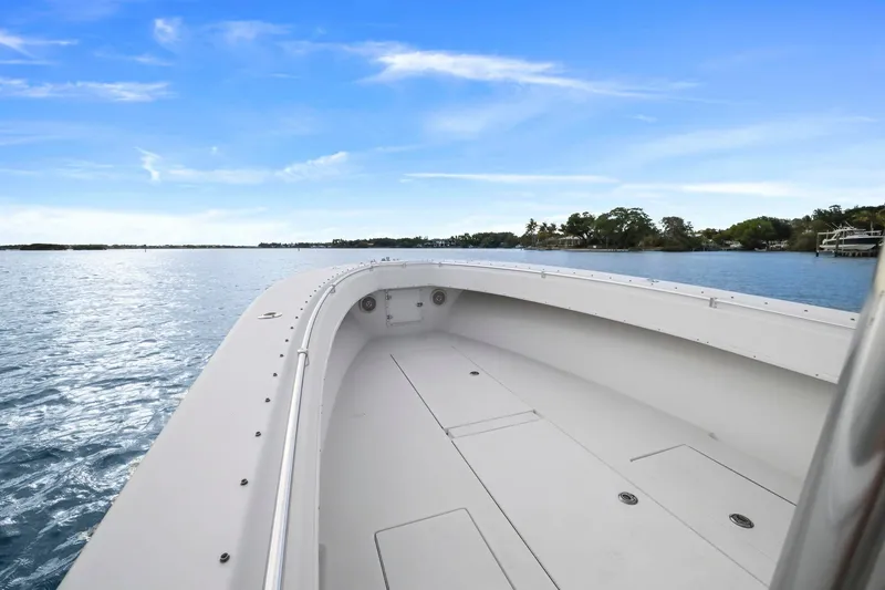 Slide: The Image of 2002 Contender 31 Open boat on calm water under clear blue sky. - 11