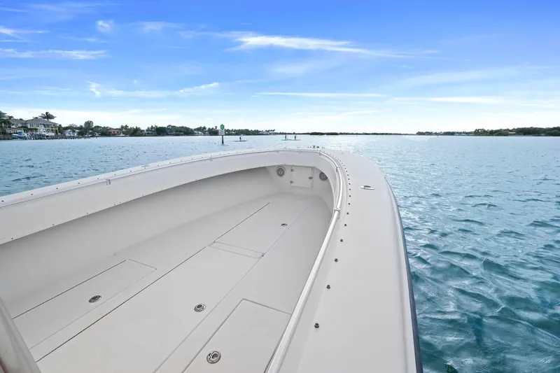 Slide: The Image of 2002 Contender 31 Open boat on calm blue waters under clear sky. - 12