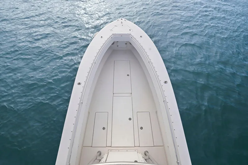 Slide: The Image of Bow view of a 2002 Contender 31 Open boat on calm water. - 13