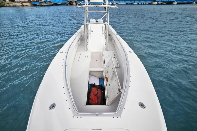 Slide: The Image of 2002 Contender 31 Open boat on water, open storage compartments visible. - 14